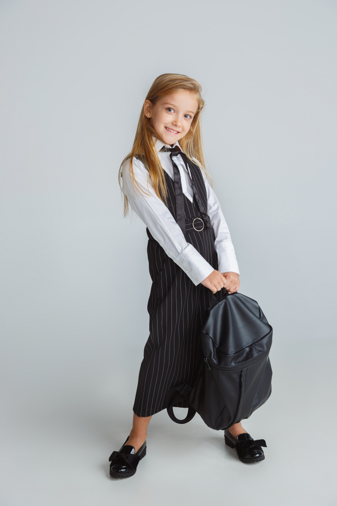 little-girl-posing-school-s-uniform-with-backpack-white-wall.jpg